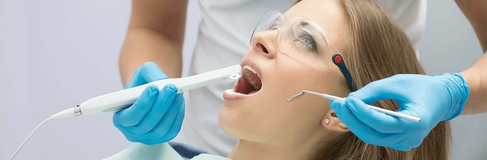 Woman receiving laser dental treatment