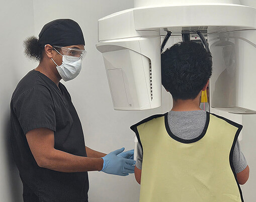 dental assistant with patient about to give xrays